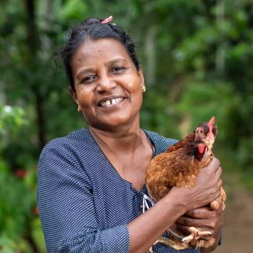 This woman's family is given a way out of poverty through income generating gifts of a pair of chickens through GFA World gift distribution