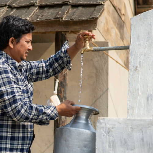 Man from Nepal collecting clean water through GFA World Jesus Wells