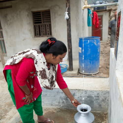 Woman from Nepal collects clean water through GFA World Jesus Wells