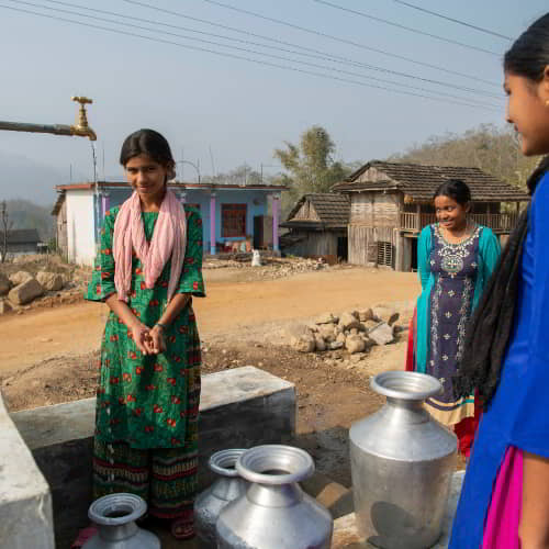 Women drawing clean water through GFA World Jesus Wells in Nepal