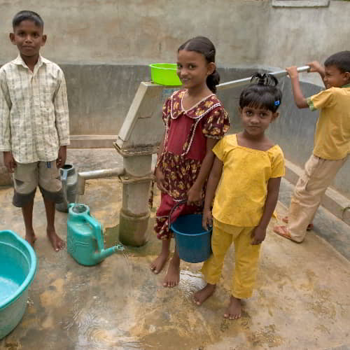 Children from Sri Lanka drawing clean water through GFA World Jesus Wells