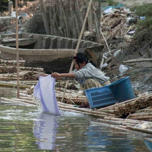 Woman from Myanmar washing using impure river water