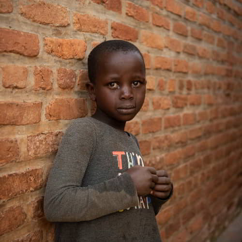 Crying young boy in poverty from Rwanda, Africa