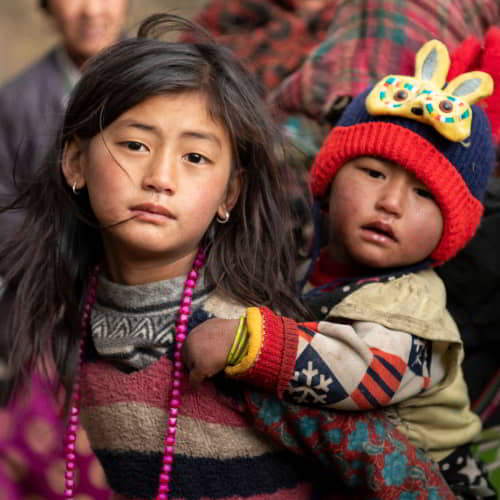 Young girl and her sibling in poverty from Nepal