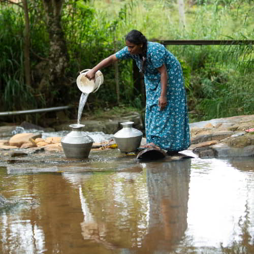 Woman from Sri Lanka collects contaminated water