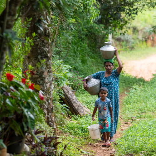 Mother and son from Sri Lanka travel long distances to collect water that is often impure