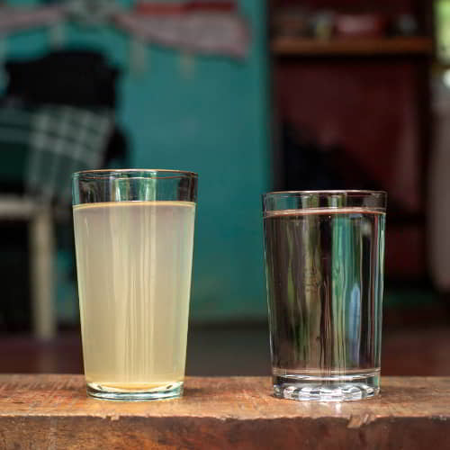 Contrasting a glass of clean water with a glass of dirty water
