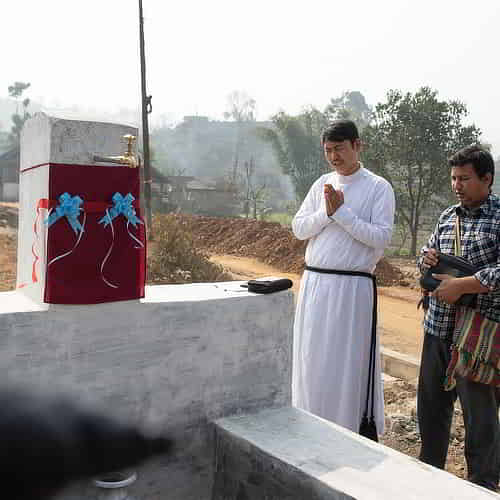 GFA World national missionary praying for the village and the installed Jesus Well